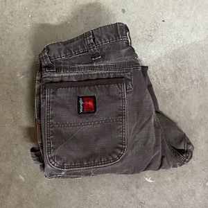 Distressed canvas wrangler worm pants. Carpenter double knees